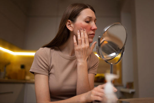 1. A woman gazes at her reflection in the mirror, examining her face with a thoughtful expression.