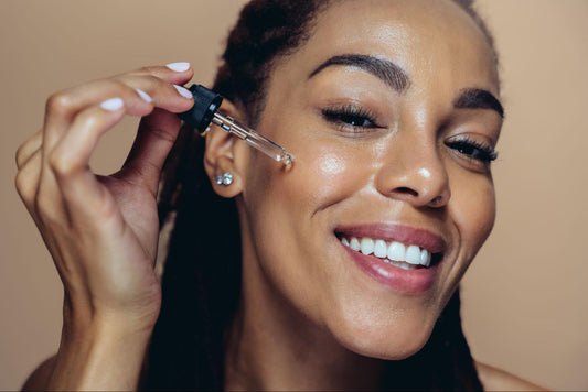 A woman smiles while brushing her hair, showcasing a moment of joy and self-care.