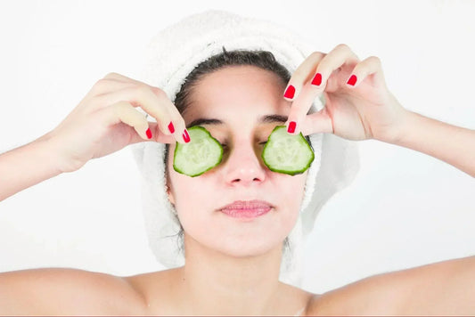 Girl using cucumber on her skin