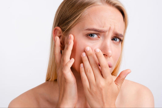 A woman with her hands on her face, expressing surprise or contemplation.