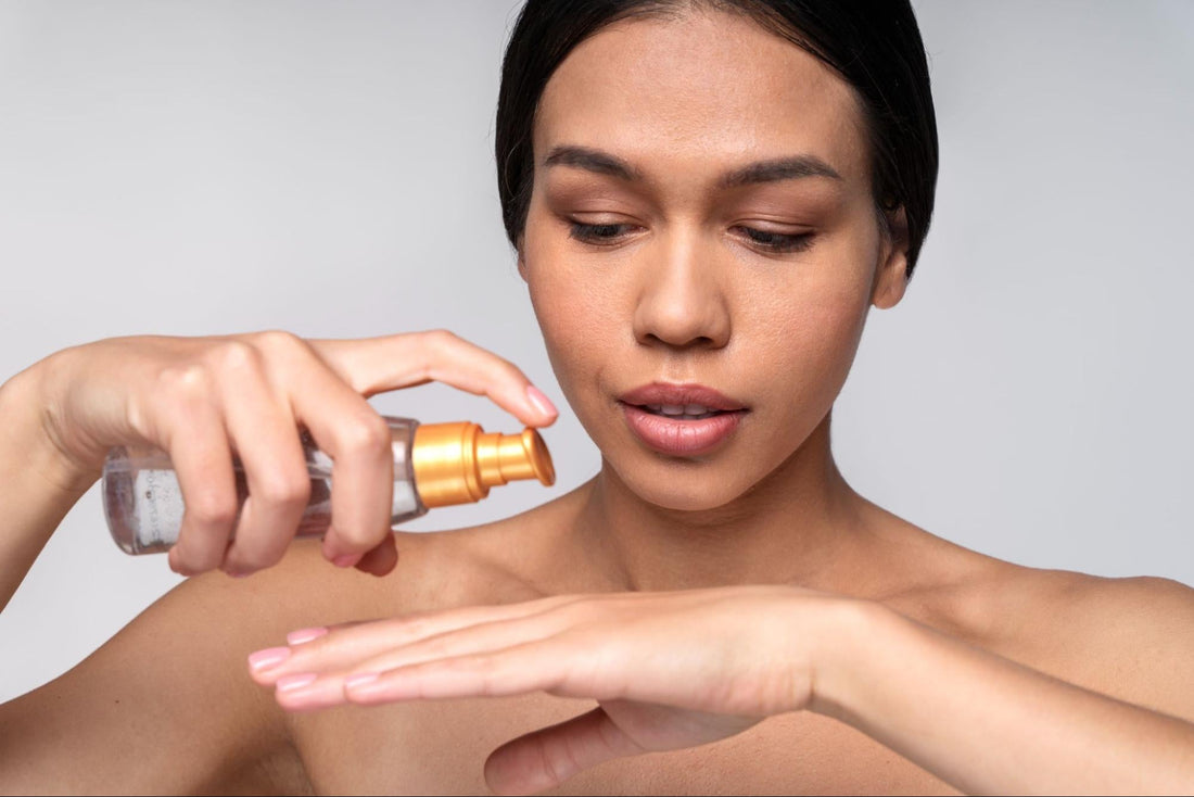 A woman applying a skin care product from a bottle to her face, focusing on her skincare routine.