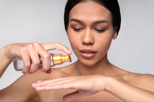 A woman applying a skin care product from a bottle to her face, focusing on her skincare routine.